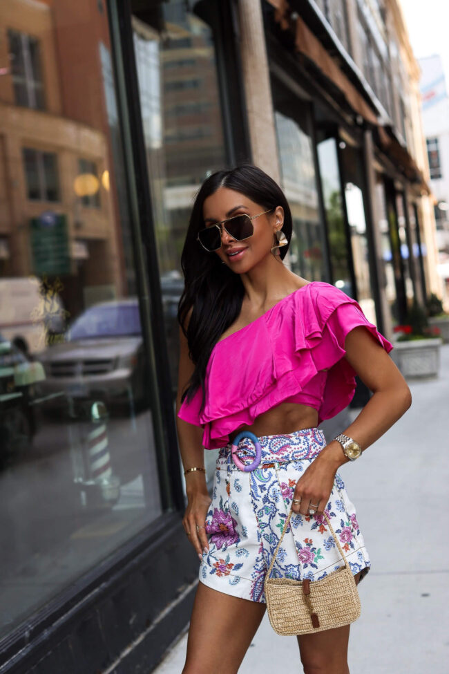 fashion blogger mia mia mine wearing a pink off shoulder top and mini saint laurent bag from saks