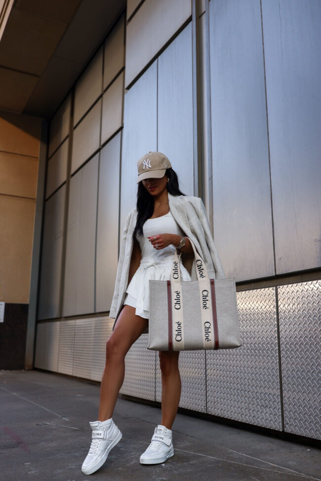 fashion blogger mia mia mine wearing a white ruffle romper from nordstrom