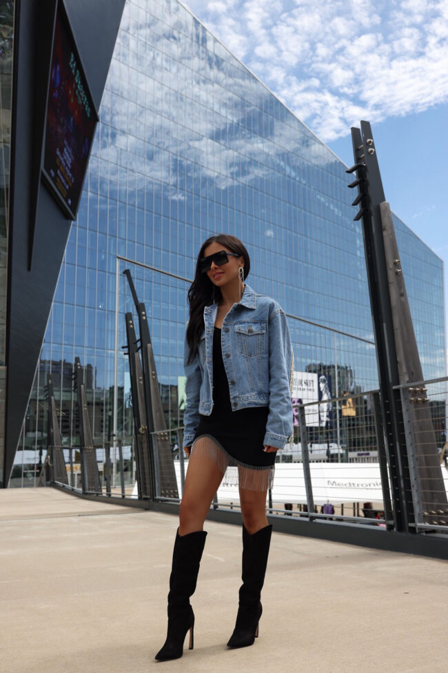 fashion blogger wearing a rhinestone denim jacket for a country concert
