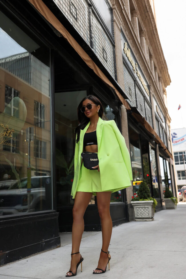 woman wearing a lime green blazer and shorts for summer