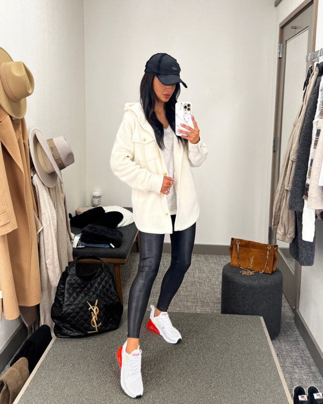 fashion blogger mia mia mine wearing a white shacket and nike air max 270 sneakers