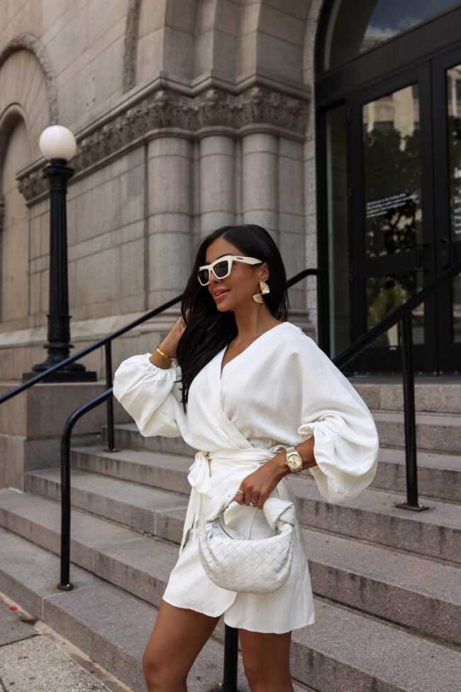 fashion blogger mia mia mine wearing a white dress with amazon gold earrings