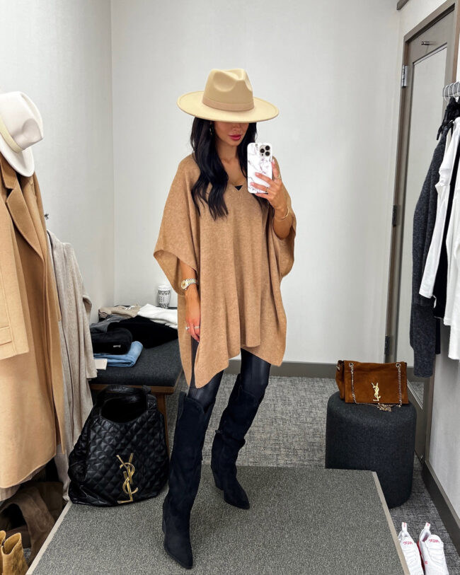 fashion blogger mia mia mine wearing a camel poncho and knee-high boots