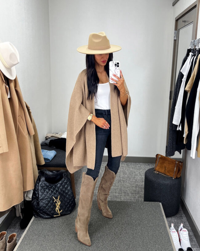 fashion blogger mia mia mine wearing a camel poncho and tall western boots from the NSALE