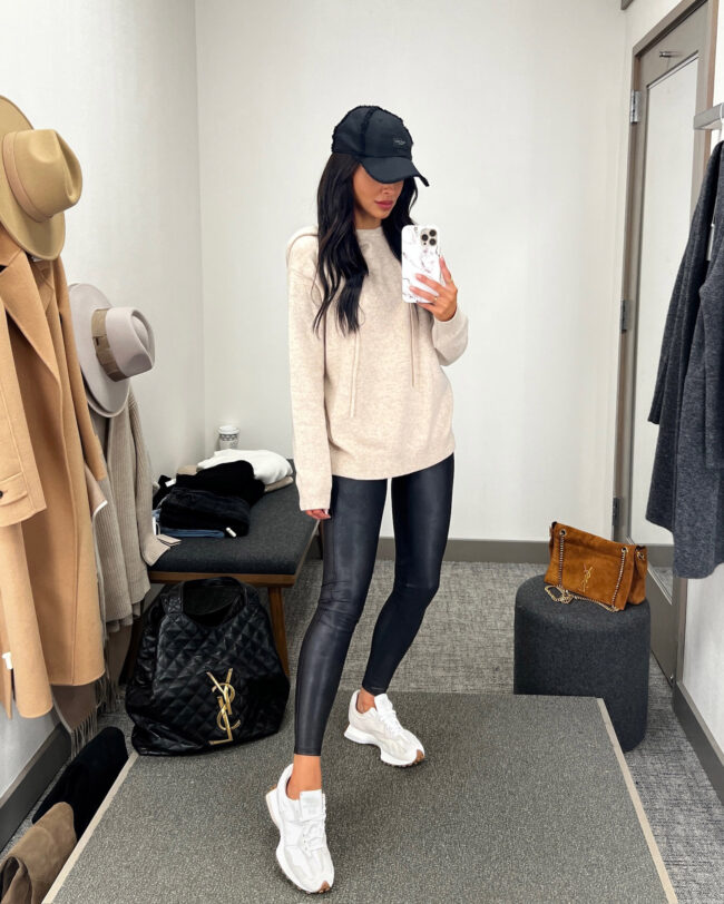 fashion blogger mia mia mine wearing a knit hoodie and faux leather leggings