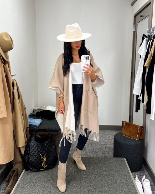 fashion blogger mia mia mine wearing a reversible poncho from the nsale