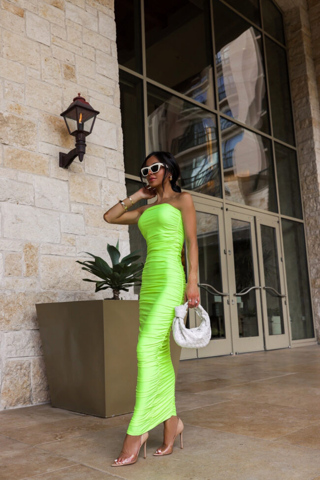 brunette fashion blogger wearing a neon green tube dress