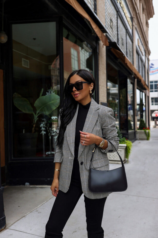 fashion blogger mia mia mine wearing a plaid blazer and black denim from walmart 