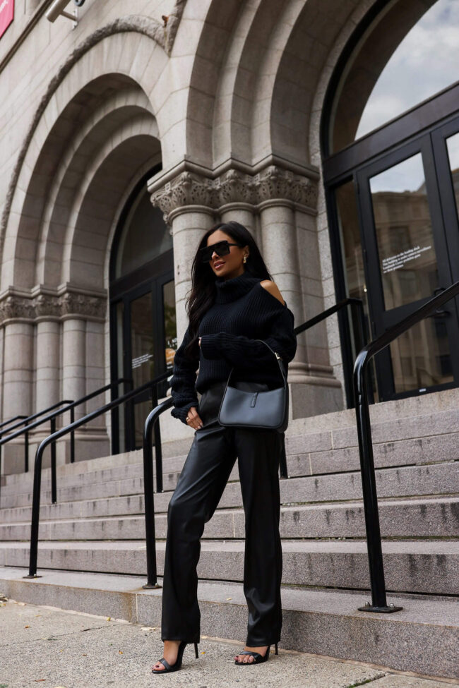 fashion blogger mia mia mine wearing a black chunky knit sweater and faux leather pants from walmart