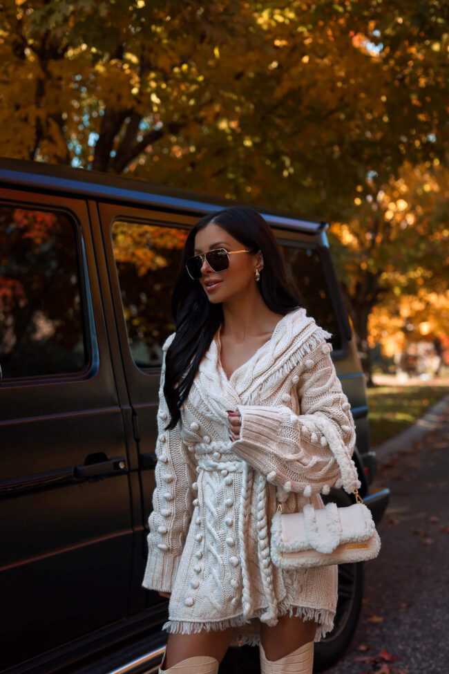 fashion blogger wearing a cable knit cardigan from saks