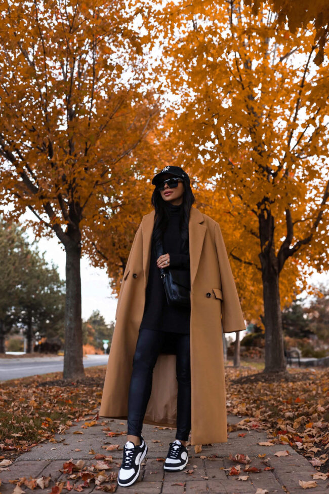 fashion blogger wearing a camel coat and black leather effect leggings from walmart