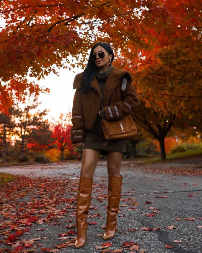 fashion blogger wearing a sweater dress outfit from revolve
