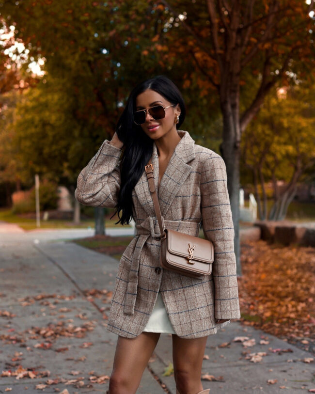 fashion blogger wearing a plaid blazer and faux leather skirt from revolve