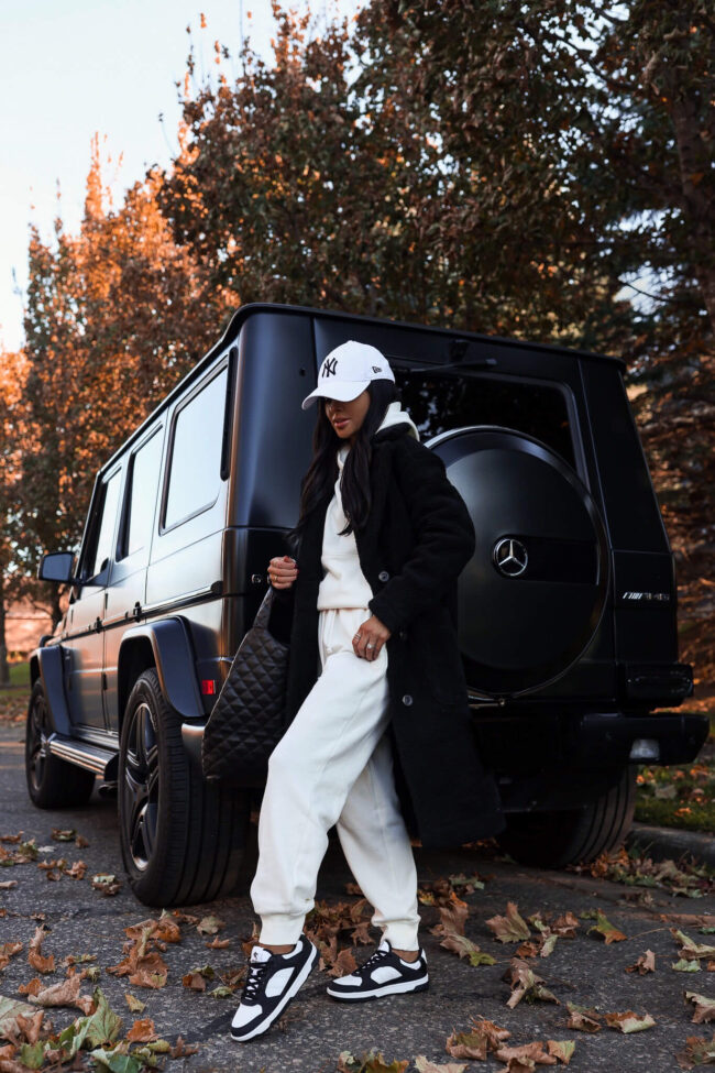 fashion blogger mia mia mine wearing black and white sneakers from walmart with a white sweatsuit