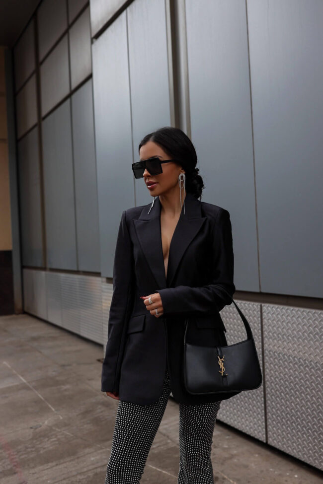 fashion blogger mia mia mine wearing a black blazer and sequin pants from saks