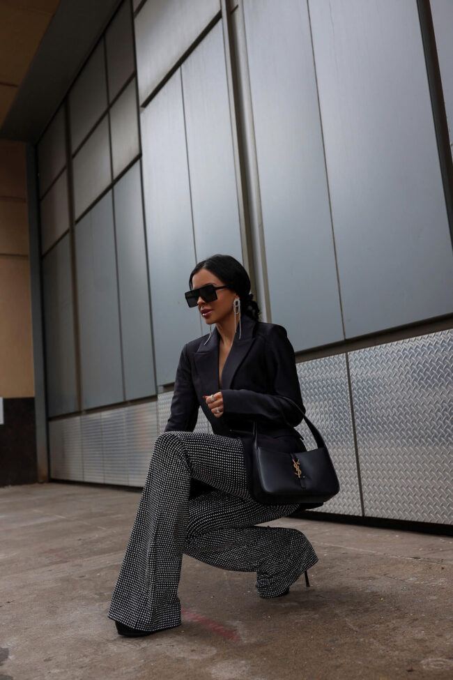 mia mia mine wearing sequin flare pants and a black blazer by good american