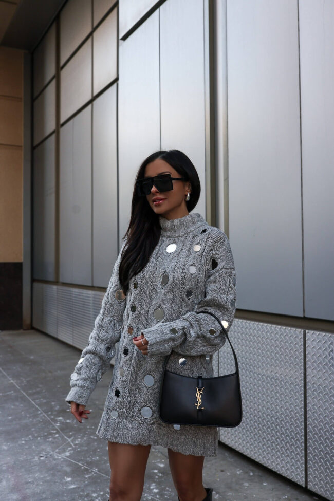 fashion blogger mia mia mine wearing a staud sweater dress for the holidays