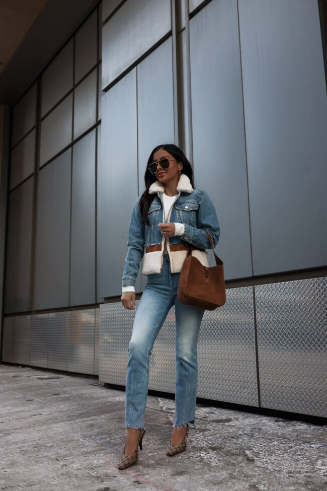 fashion blogger mia mia mine wearing a denim shearling jacket from saks