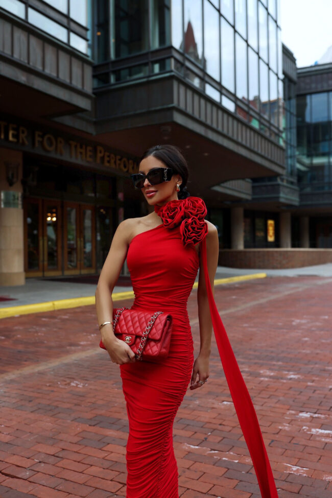 fashion blogger wearing a red one-shoulder dress