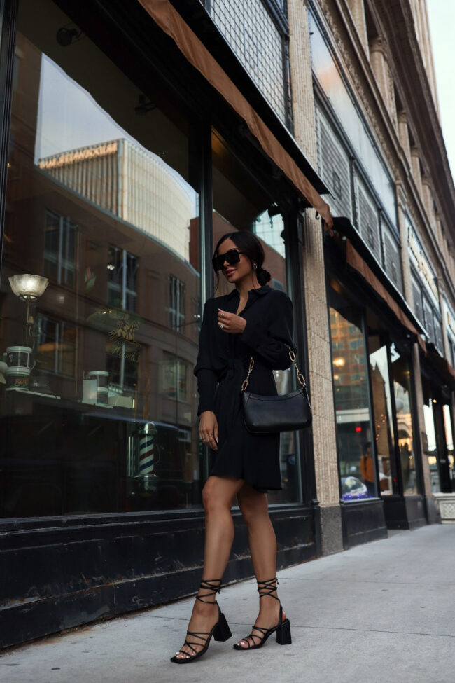 fashion blogger mia mia mine wearing a black wrap mini dress from walmart