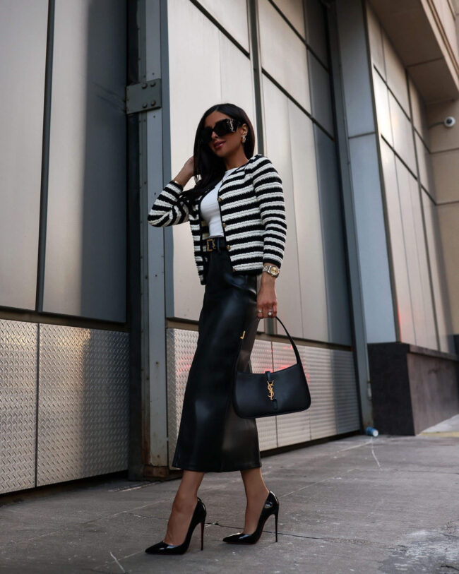 fashion blogger mia mia mine wearing a black and white striped cardigan and a faux leather skirt from nordstrom