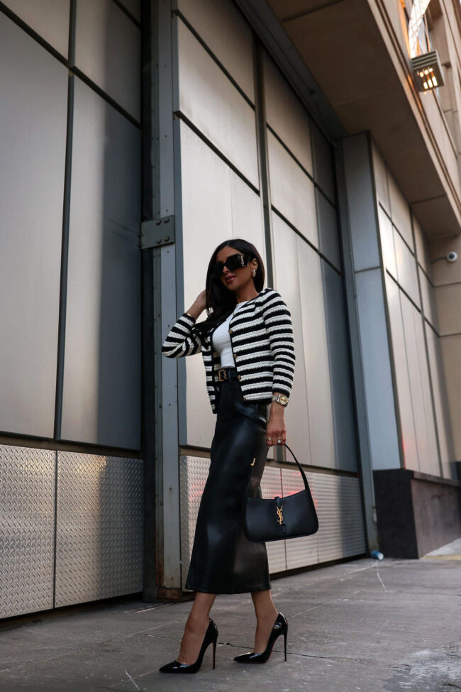 fashion blogger mia mia mine wearing a black and white striped cardigan and a faux leather skirt from nordstrom