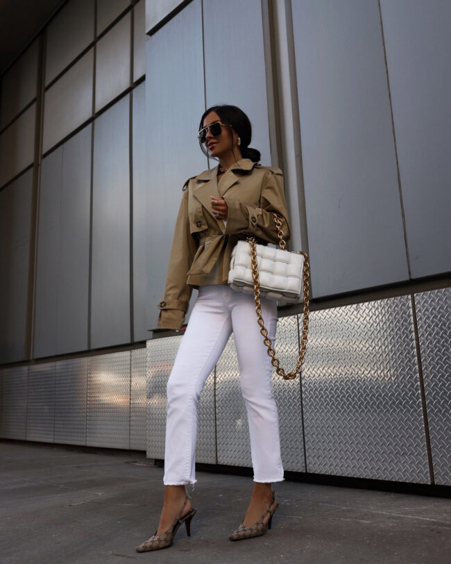 fashion blogger wearing a cropped trench coat from saks