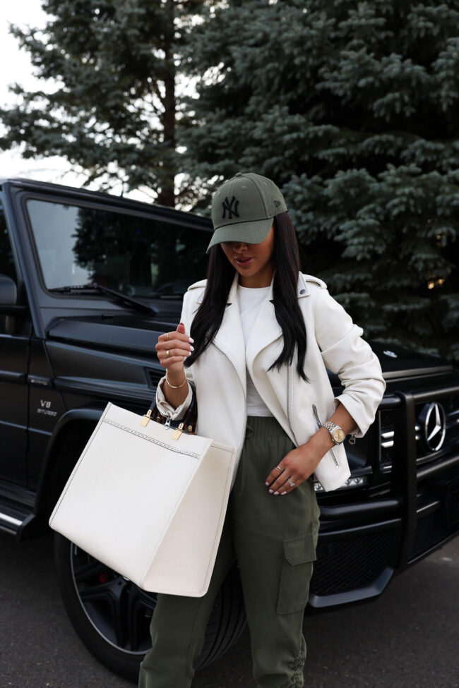 fashion blogger mia mia mine wearing a white faux leather jacket from walmart for spring