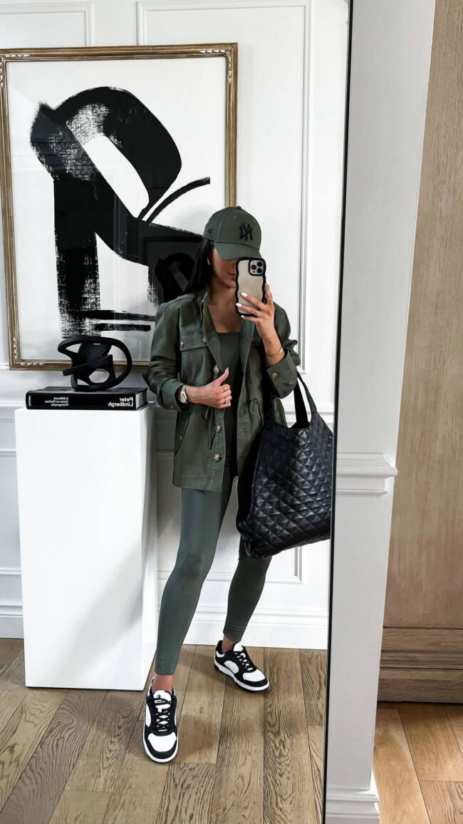 fashion blogger mia mia mine wearing a green jumsuit and green utility jacket from walmart