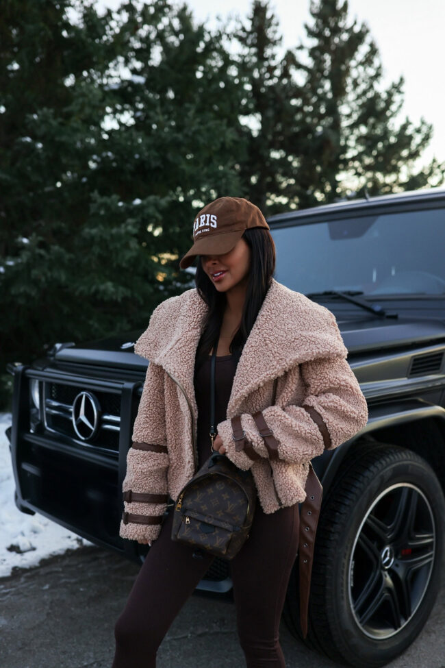 mia mia mine wearing a camel shearling moto jacket from revolve