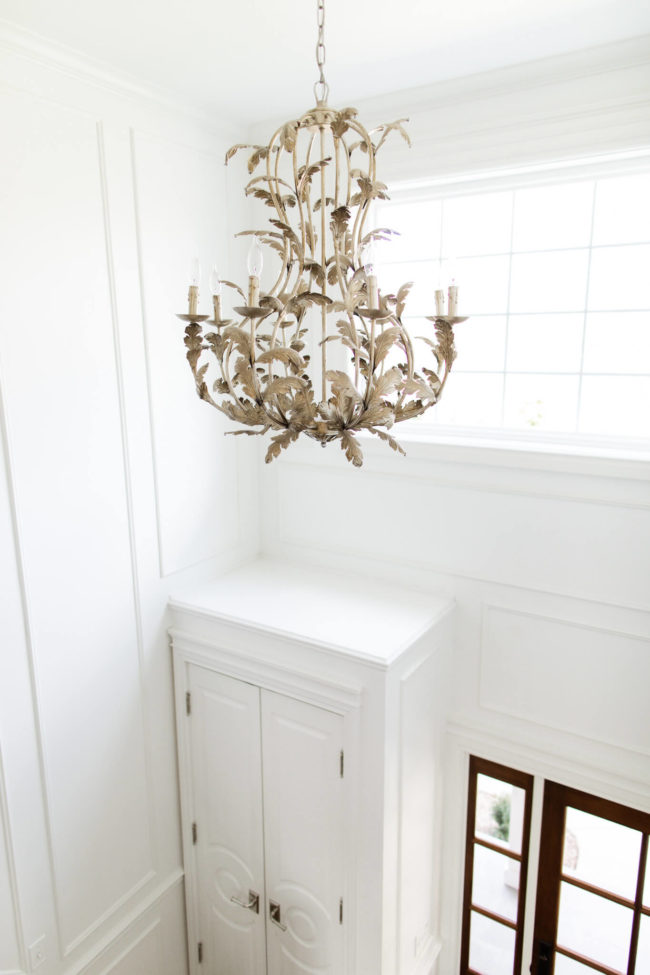 gold chandelier in fashion blogger's entryway