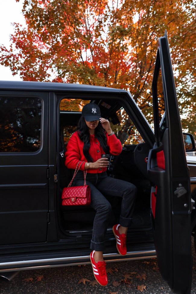 fashion blogger wearing a red cardigan from free people for fall
