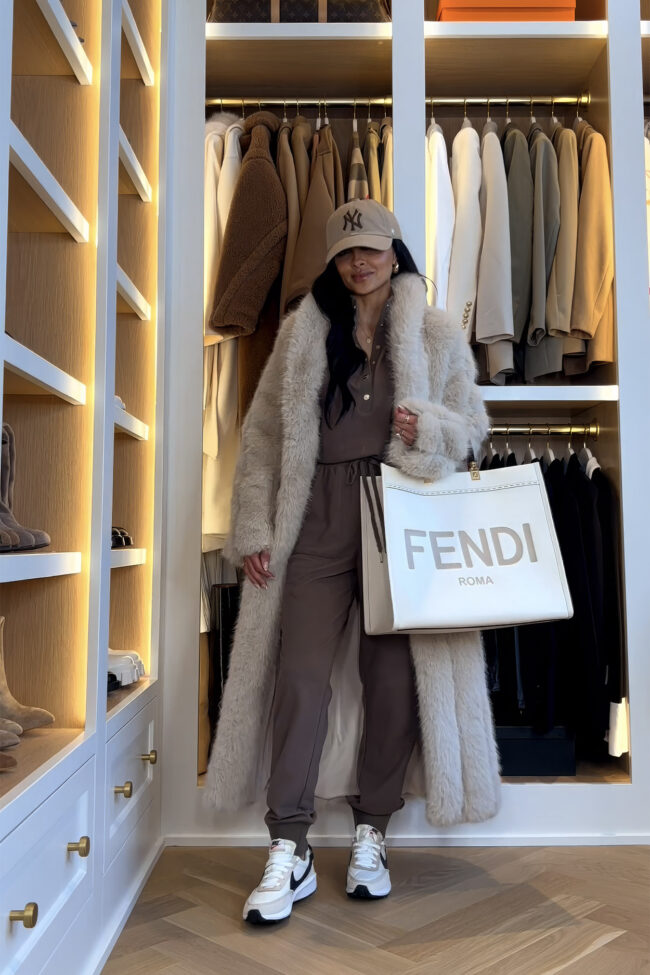 mia mia mine wearing a long faux fur coat and casual jumpsuit