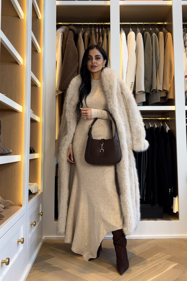 mia mia mine wearing an asymmetrical sweater dress with schutz slouchy suede boots