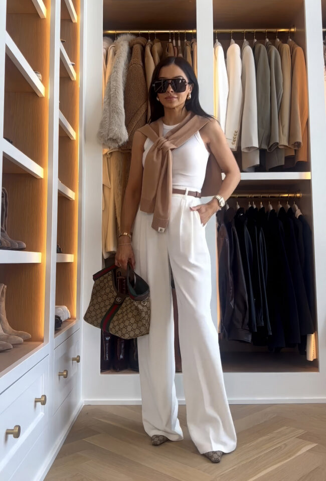 mia mia mine wearing amazon shawl with white trousers