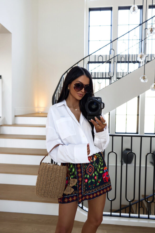 mia mia mine wearing the mother scrunchie frenchie white button up shirt with an amazon printed skort