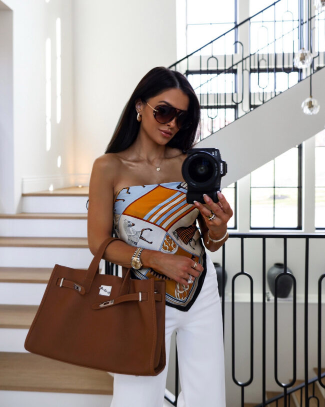 mia mia mine wearing a scarf top and birkin inspired bag from amazon