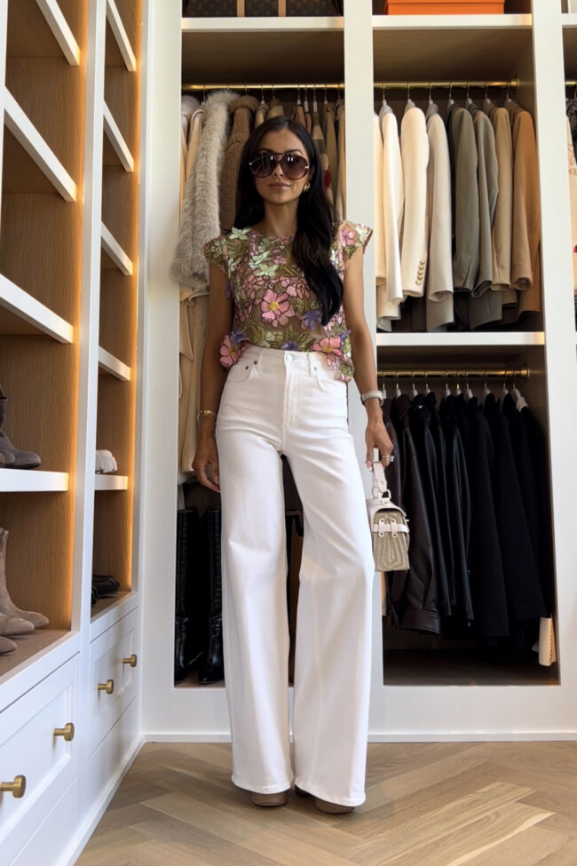 mia mia mine wearing citizens white wide leg jeans with an anthropologie floral tee