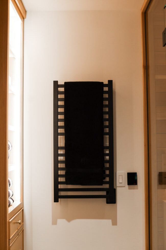 Black Amba heated towel rack in luxury home spa bathroom