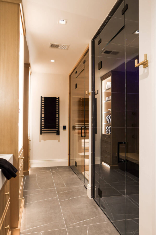 Luxury spa bathroom with glass steam shower, sauna and Amba heated towel rack