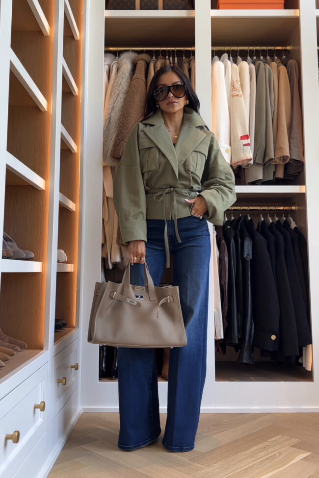 brunette fashion blogger wearing a revolve green jacket with mother hustler jeans